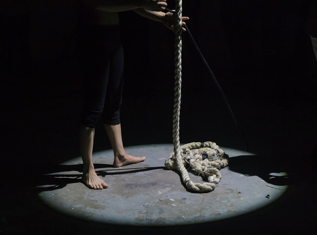 Photo of a rope at someones feet